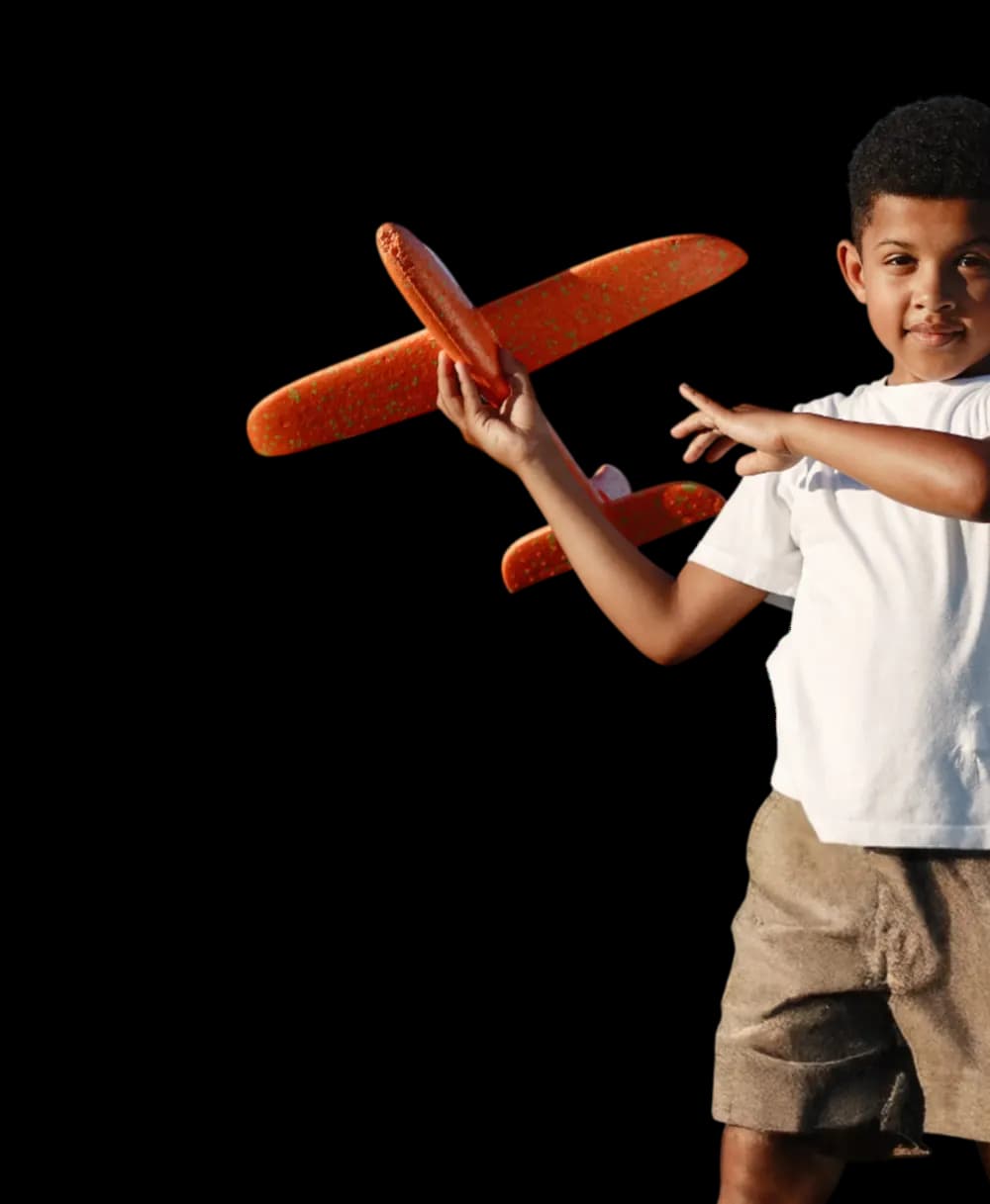 Boy with plane representing our mission and vision